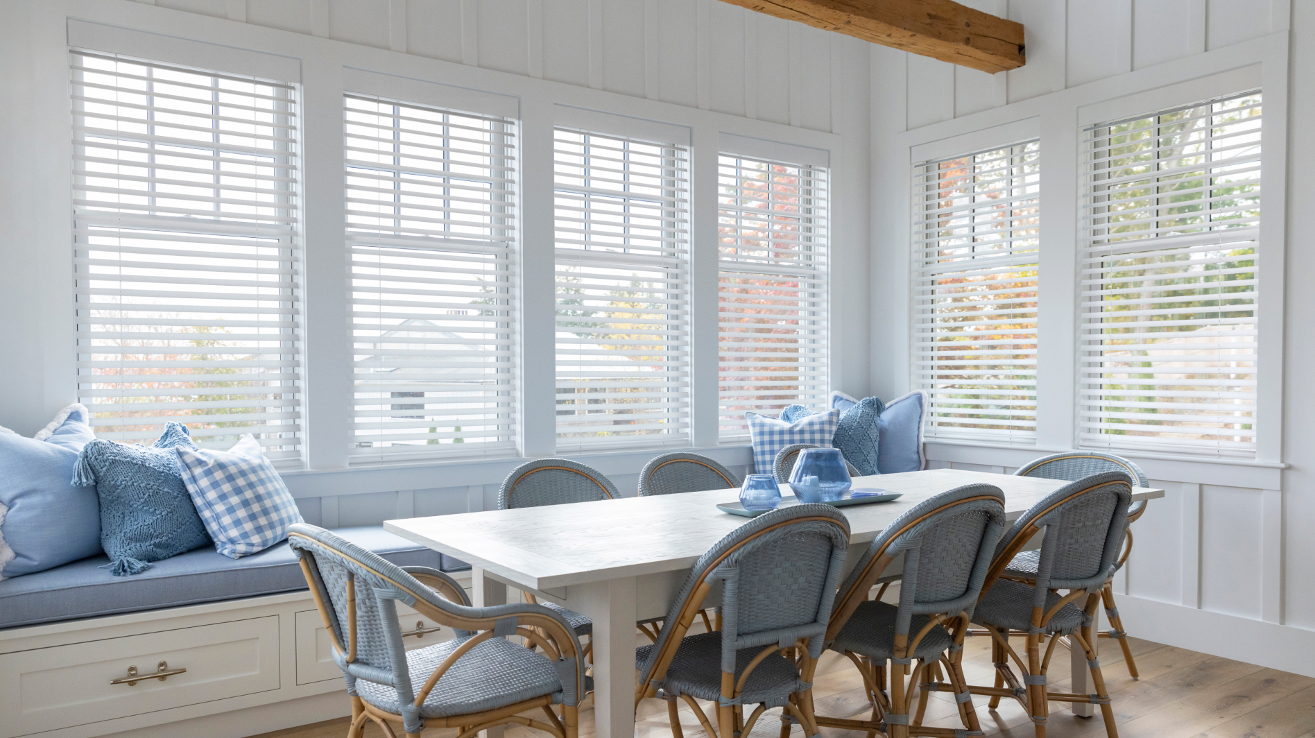 Dining room with Caséta smart shades and blinds controlling natural light through multiple windows