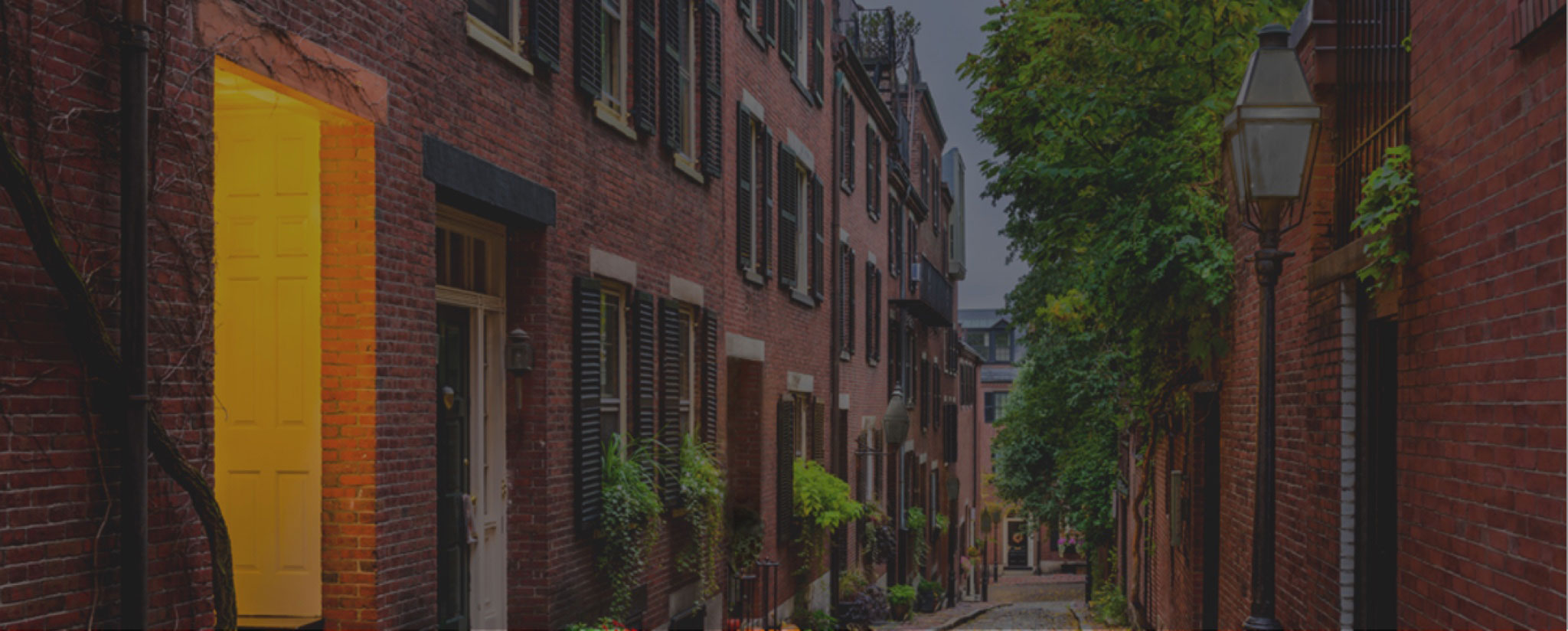 Alley of brick townhomes with greenery and smart light switch